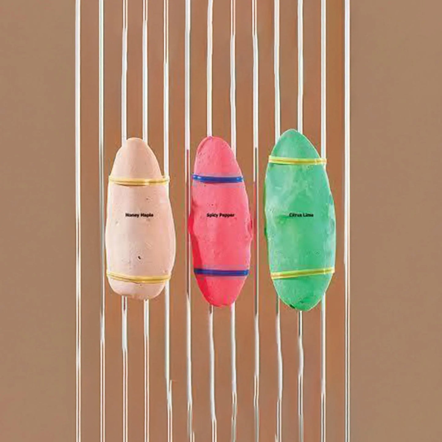 Three colorful cuttlebones in Honey Maple, Spicy Pepper, and Citrus Lime flavors, packed with essential calcium for birds.