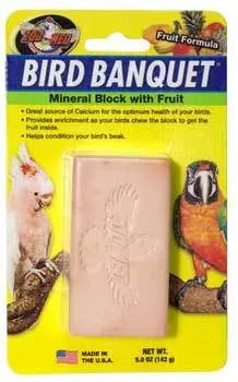 Vibrant Zoo Med Bird Banquet Mineral Block in fruit flavor, featuring tropical mango, banana, papaya, and pineapple hues.