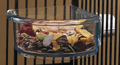 Durable 7oz In & Out Corner Crock with a transparent, no-tip design, securely fastened to a pet cage for spill-free feeding.
