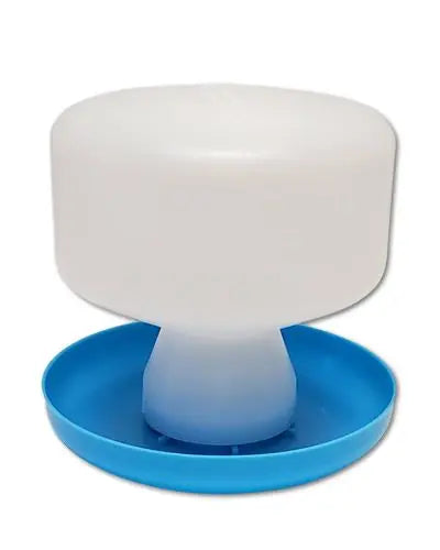 Clear 24oz gravity-feed waterer with a visible water level, made of durable polyethylene and a sturdy polystyrene base.