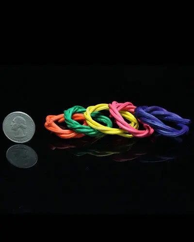 Vibrant set of four small colored vine rings, crafted from 100% natural materials, perfect for bird toys, roughly 1.75 inches in diameter.