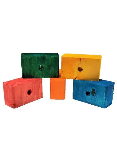 Vibrant colored pine blocks in a 3.5" x 2" x 1.5" size, showcasing a mix of hues with a small half-inch hole detail.