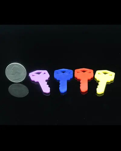 Brightly colored 2-inch plastic keys in assorted shades, perfect as engaging bird toy parts with a playful design.