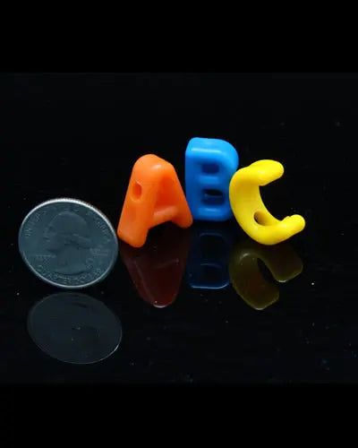 Colorful assortment of small plastic letters for bird toys, measuring 3/4 inch long, perfect for playful pet engagement.
