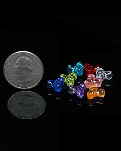 Colorful mini triangle beads in assorted hues, perfect for crafting bird toys, with about 190 tiny plastic pieces per ounce.