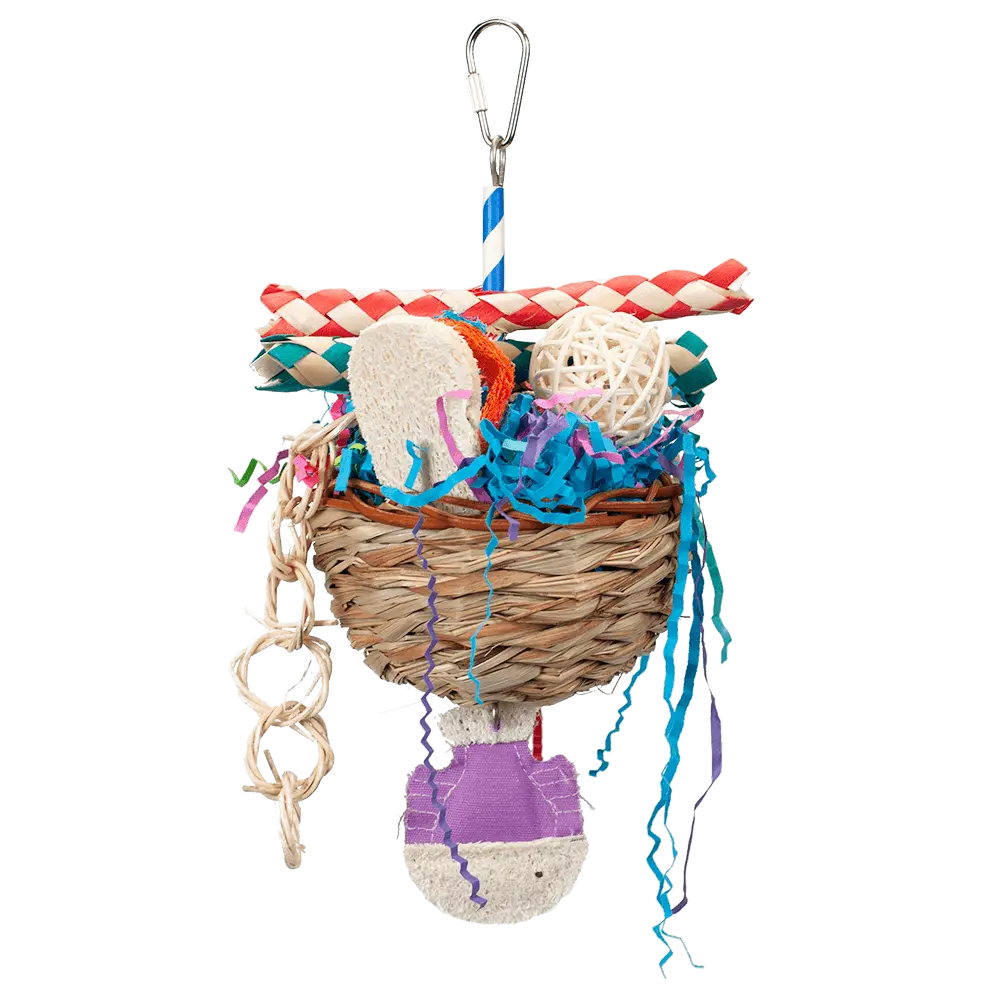 Colorful Happy Beaks Tackle Box toy with a palm and wicker basket, stuffed with crinkle paper, loofah, and vine balls for birds.