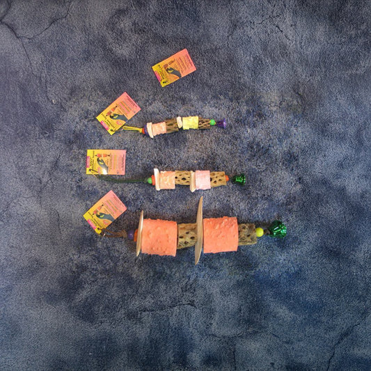 Vibrant Polly's Cuttlebone Secrets toy for large birds, featuring cuttlebone, cholla wood, calcium chunks, and a fun liberty bell.