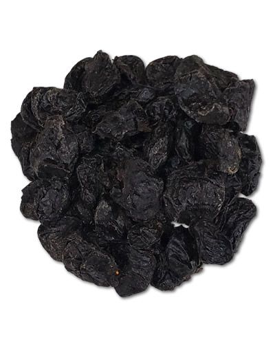 Dried pitted prunes in a pile, showcasing their deep purple hue and chewy texture, perfect for birds or snacking.