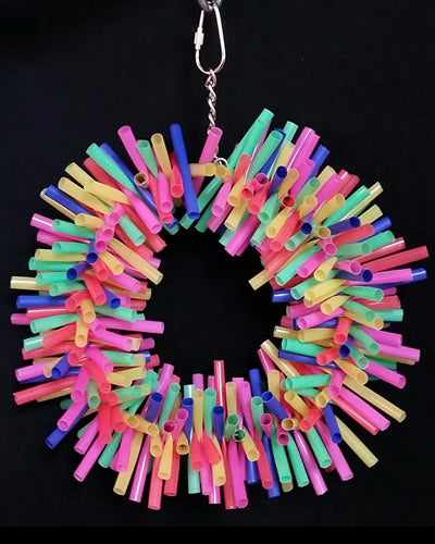 Vibrant neon-colored straws woven into a 9-inch wreath, perfect as a foraging bird toy for small to medium birds.