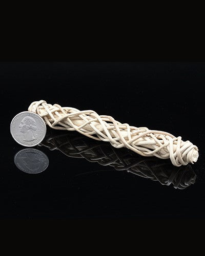 Delicate wicker twist toy part, crafted from 100% natural materials, showcasing a woven texture, about 5 inches long.