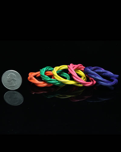 Vibrant set of four small colored vine rings, crafted from 100% natural materials, perfect for bird toys, roughly 1.75 inches in diameter.