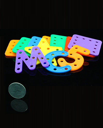Colorful plastic bird toy parts featuring letters, numbers, and shapes, each measuring about 1.5 inches by 1.5 inches.