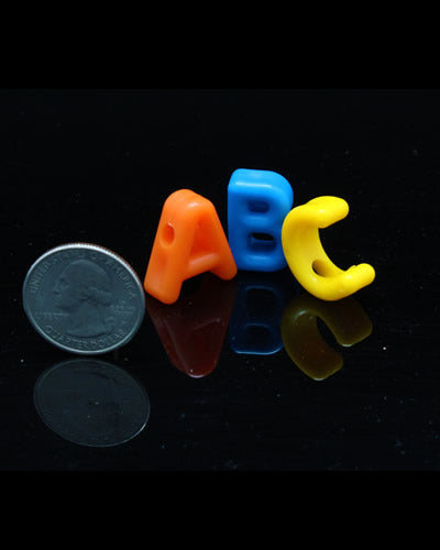 Colorful assortment of small plastic letters for bird toys, measuring 3/4 inch long, perfect for playful pet engagement.