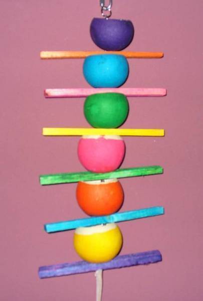 Vibrant Caterpillar Jungle Toy with colorful wood slats and fillable cups for birds to forage treats, sized 15x7 inches.