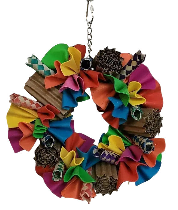 Vibrant Ruffle Swing bird toy with colorful foam sheets, bamboo finger traps, and cardboard rolls for playful pecking.