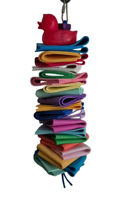 Vibrant multi-colored foam squares stacked creatively with a playful plastic toy on top, perfect for medium-sized birds.